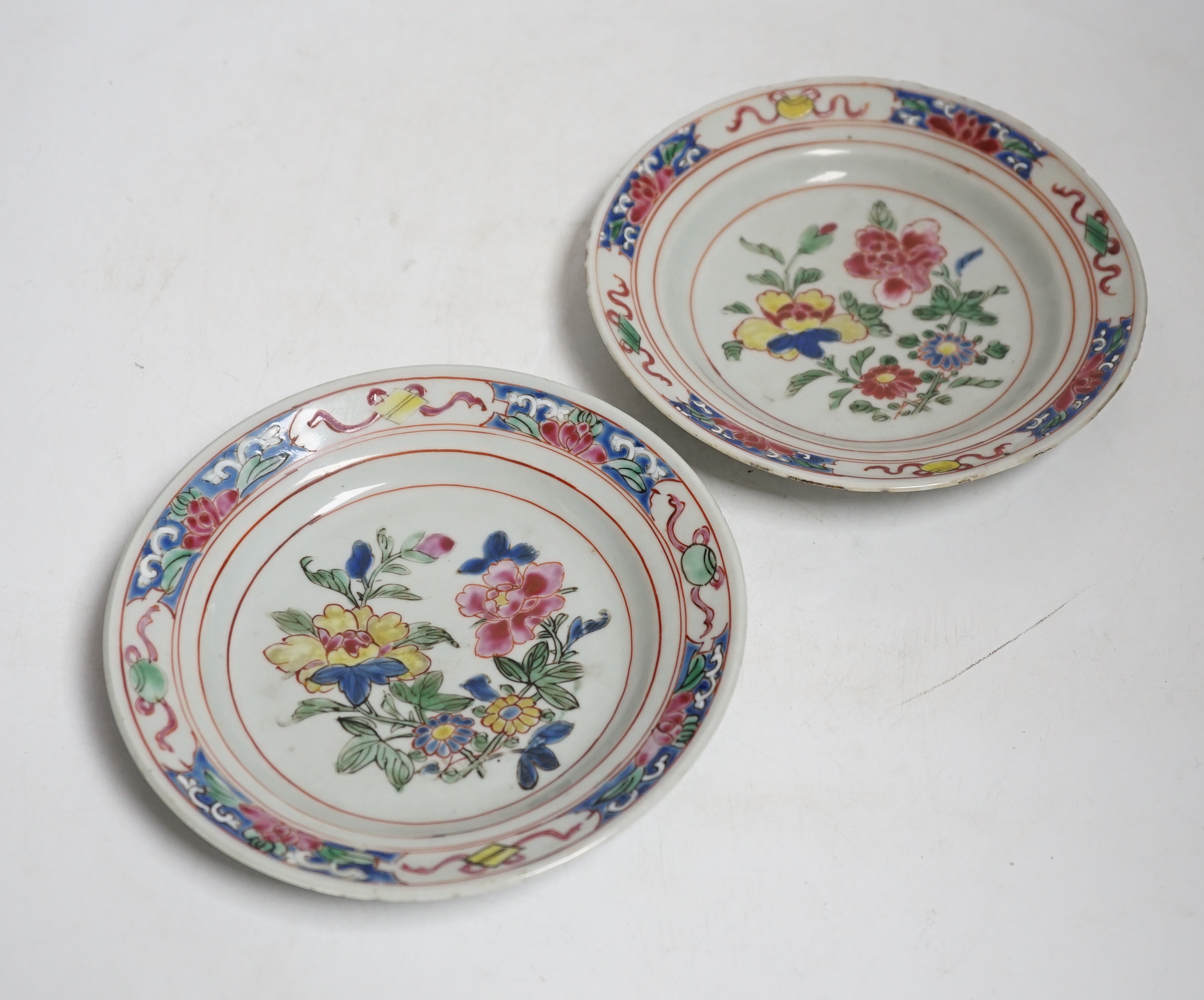 A pair of Chinese famille rose fencai small plates, early Yongzheng period, 16 cms diameter